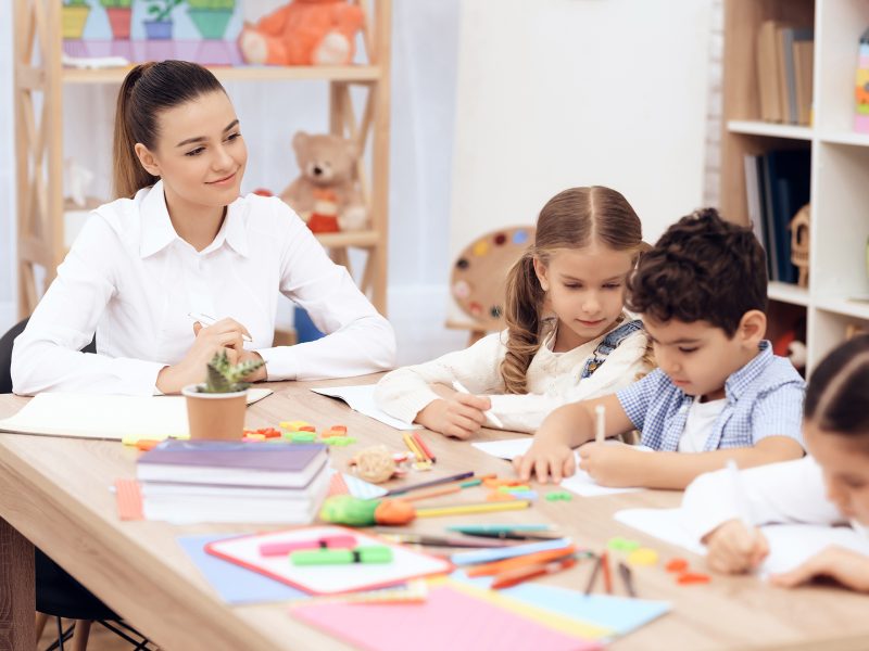 Kids in Kindergarten learn to draw with pencils.