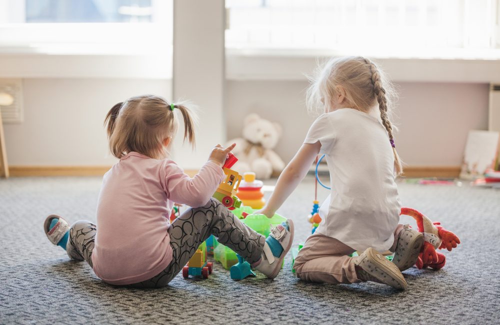 two-little-girls-sitting-floor-playing